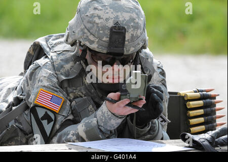 U.S. Army soldier uses a compass to draw a range map in Grafenwoehr, Germany. Stock Photo