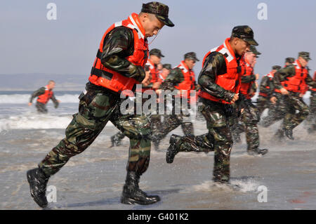 Students in Basic Underwater Demolition/SEAL (BUD/S) participate in a surf passage exercise. Stock Photo