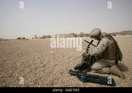 A field radio operator sets up satellite communication. Stock Photo