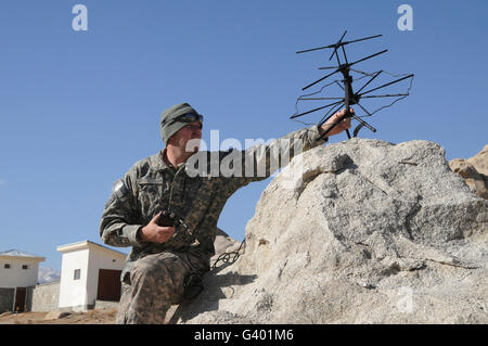 U.S. Army soldier sets up a tactical satellite. Stock Photo