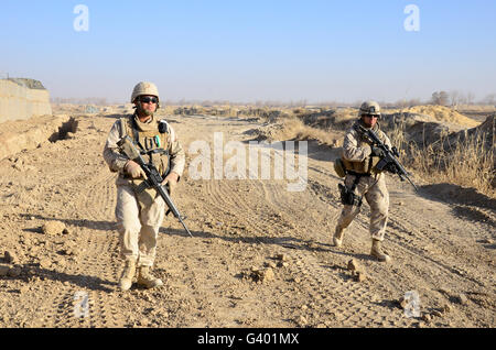 Soldiers conduct a perimeter security check around a combat outpost in Diwar, Afghanistan. Stock Photo