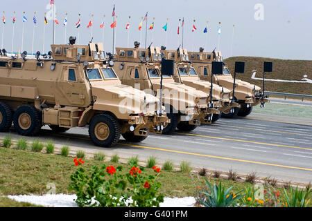 U.S. Army Caiman vehicles take part in the 50/20 Celebration parade in Kuwait. Stock Photo