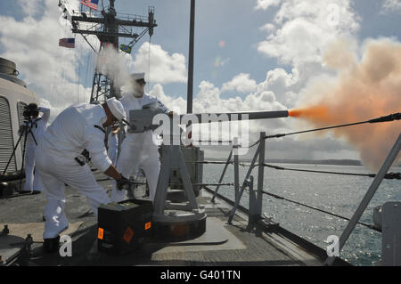 Sailors fire the 40mm saluting battery aboard USS Boone. Stock Photo