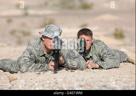 Soldiers look through the scope of their Barret M107 .50 caliber sniper rifles. Stock Photo