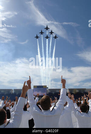 Members of the U.S. Naval Academy cheer as the Blue Angels perfom during graduation. Stock Photo