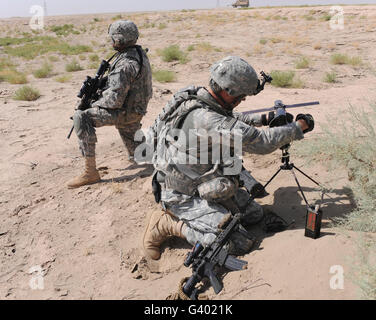 U.S. Army soldier sets up a satellite communications radio. Stock Photo