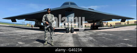 An Airman guards a B-2 Spirit at Ellsworth Air Force Base. Stock Photo