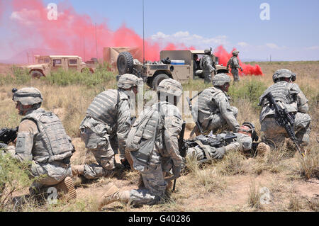 Soldiers prepare to transport a wounded soldier during a medical evacuataion. Stock Photo