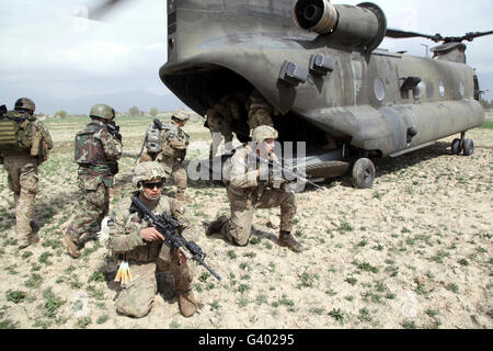 U.S. Army soldiers board a CH-47 Chinook helicopter in Afghanistan. Stock Photo