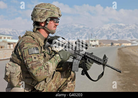 U.S. Army Specialist provides security during a convoy stop in Afghanistan. Stock Photo