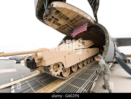 Airmen load a tank into a C-5M Super Galaxy at Dover Air Force Base. Stock Photo