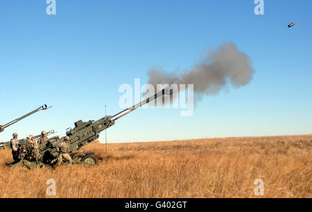 Soldiers fire a 155mm M777 Lightweight Howitzer. Stock Photo