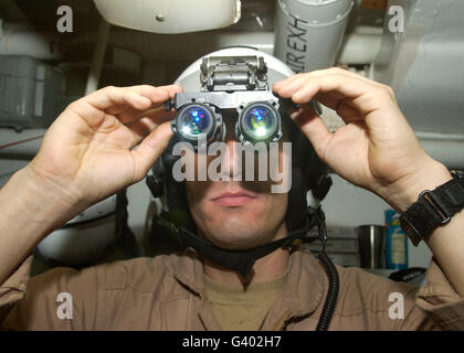 Sailor adjusts his AN/AVS-9 night vision goggles. Stock Photo
