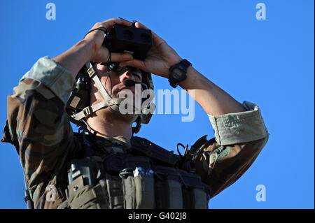 U.S. Special Operations soldier looks through a rangefinder. Stock Photo