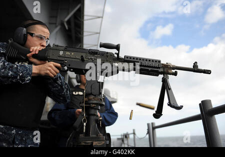 Aviation Electronics Technician fires an M240B machine gun. Stock Photo