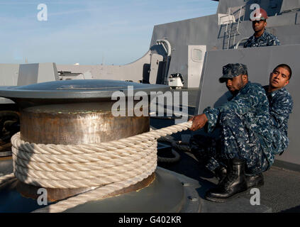 Sailors handle mooring lines aboard USS New York. Stock Photo