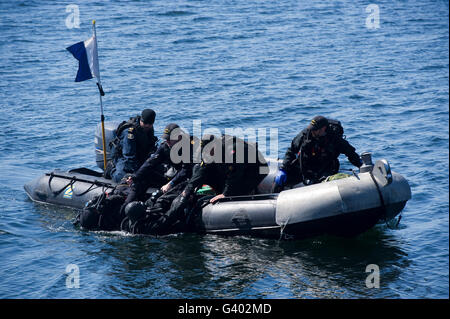 Canadian divers being helped aboard their boat. Stock Photo