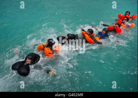 Group swimming technique during a water survival refresher class. Stock Photo