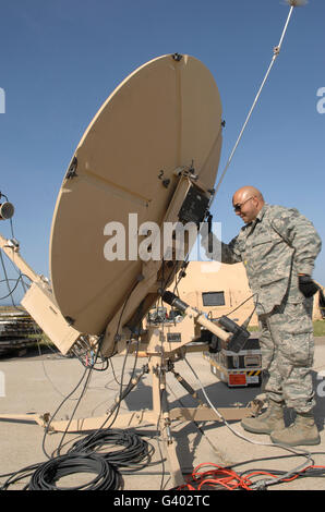 U.S. Air Force Staff Sergeant assembles a satellite communications dish. Stock Photo