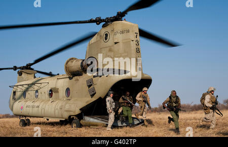 U.S. Marines exit a Hawaii Army National Guard CH-47F Chinook helicopter. Stock Photo