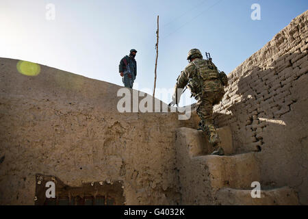 U.S. Army soldier climbs stairs to the roof of the Farah City prison. Stock Photo