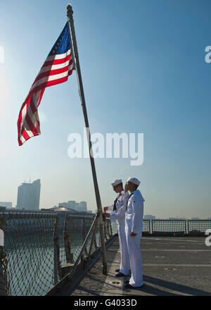 Seamen participate in morning colors on the flight deck of USS Tortuga. Stock Photo