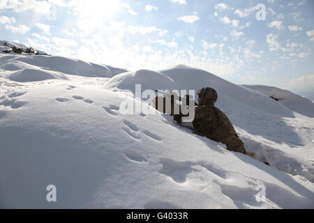 U.S. Army soldier takes up a security position in Afghanistan. Stock Photo