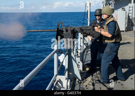 Seaman Apprentice fires  a .50-caliber machine gun. Stock Photo