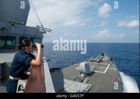 Officer of the deck monitors nearby shipping traffic aboard USS Mahan. Stock Photo