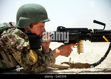 An Afghan National Army soldier fires an M240B machine gun. Stock Photo