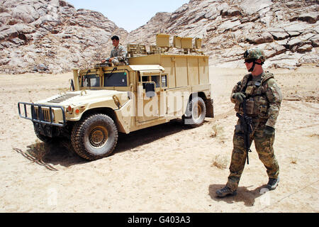 U.S. Air Force soldier guides an Afghan Border Police vehicle. Stock Photo