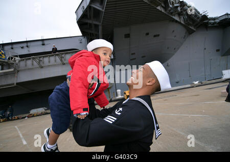 Seaman greets his son during a homecoming celebration. Stock Photo