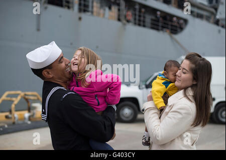 U.S. Navy sailor greets his family during homecoming. Stock Photo