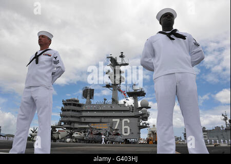 Sailors man the rails aboard USS Ronald Reagan. Stock Photo