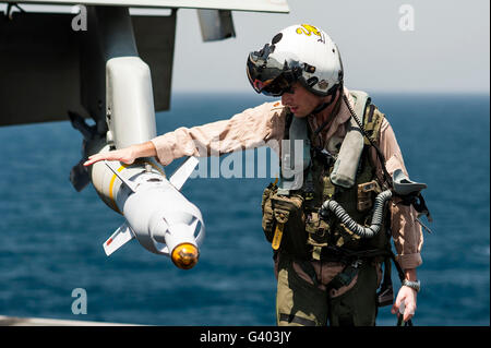 Pilot performs pre-flight checks on an F/A-18C Hornet. Stock Photo