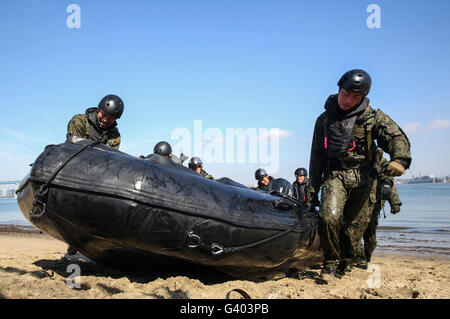 Soldiers of the Japan Ground Self-Defense Force practice amphibious landing techniques. Stock Photo