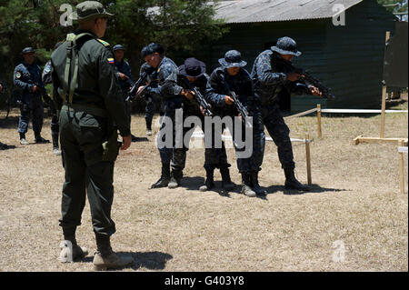 A Jungla from the Columbian National Police observes TIGRES trainees. Stock Photo