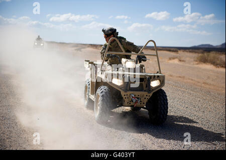 A U.S. Soldier performs off-road maneuvers with a LTATV. Stock Photo