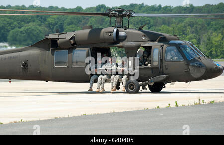 National Guard Special Forces Soldiers sit with their legs hanging outside of a UH-60. Stock Photo