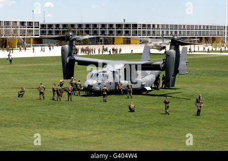 Cadets and active-duty troops swarm around a CV-22 Osprey. Stock Photo