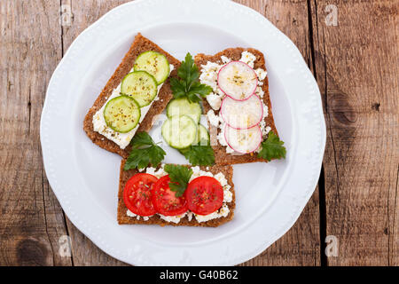 Healthy snacks for second breakfast in white plate on rustic wooden background Stock Photo