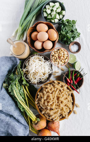 Ingredients for Crunchy Veggie Bowl with Warm Peanut Dressing are photographed from the top view. Stock Photo