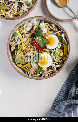 A bowl of Crunchy Veggie Bowl with Warm Peanut Dressing is photographed from the top view. Stock Photo