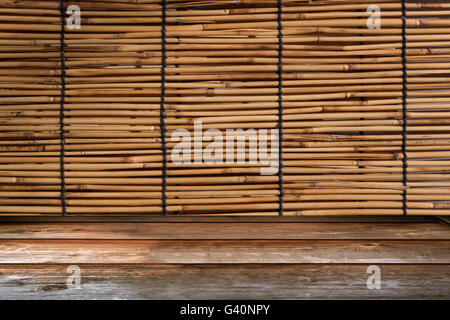 Wood tabletop in perspective view with bamboo curtain retro background Stock Photo