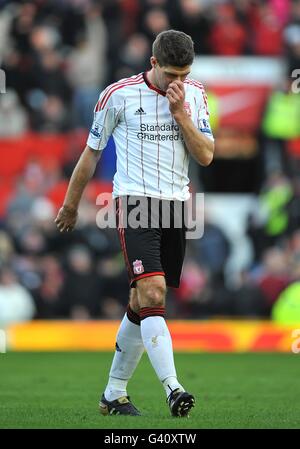 Liverpool's Steven Gerrard walks off the pitch dejected after being sent off by referee Howard Webb for a foul on Manchester United's Michael Carrick Stock Photo