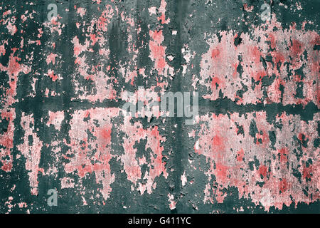Retro toned peeling paint on metal surface, grunge background. Stock Photo