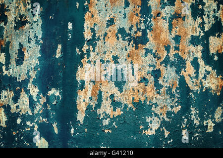 Retro toned peeling paint on metal surface, grunge background. Stock Photo