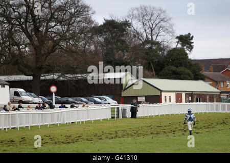 Horse Racing - Hereford Racecourse. Charlie Poste makes his way back to the jockeys room after falling on Shannons Boy during The Lindley Catering Handicap Steeple Chase Stock Photo