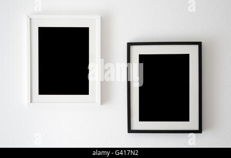 two empty frames hanging on the wall Stock Photo