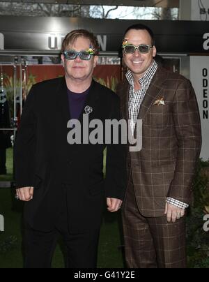 Sir Elton John and David Furnish arriving for the premiere of Gnomeo and Juliet at the Odeon Leicester Square, London. Stock Photo